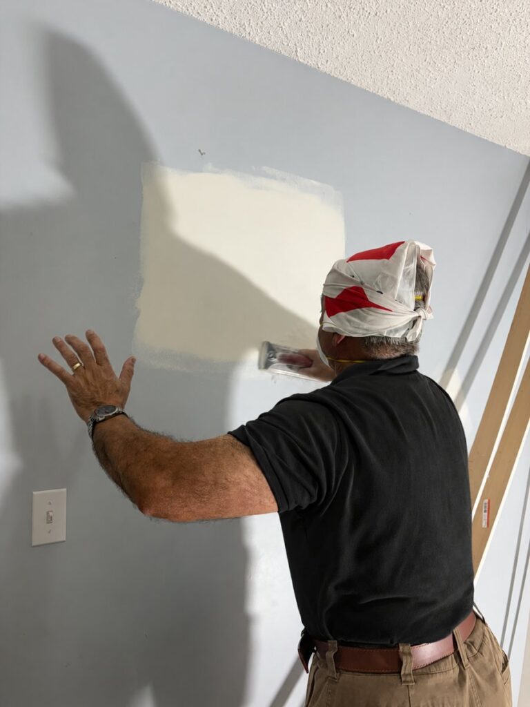 Handyman smoothing a drywall repair